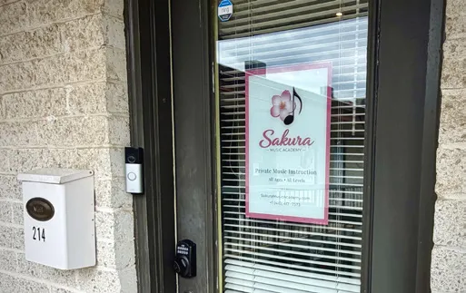 The Suite 214 door with the Sakura Music Academy sign in the window.