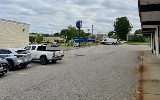The studio parking lot, with the building on the right; park on the side facing Goodwill.
